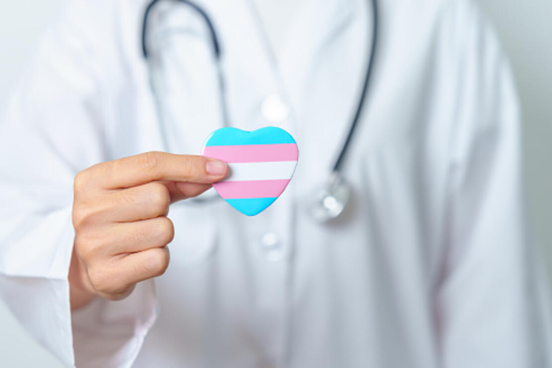 Transgender Day and LGBT pride month, LGBTQ+ or LGBTQIA+ concept. Doctor holding blue, pink and white heart shape for Lesbian, Gay, Bisexual, Transgender, Queer and Pansexual community