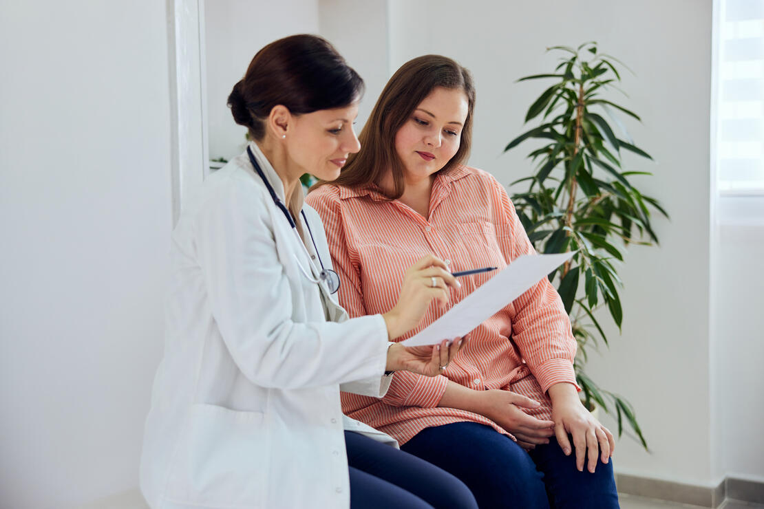 Female patient reviewing a document with her doctor