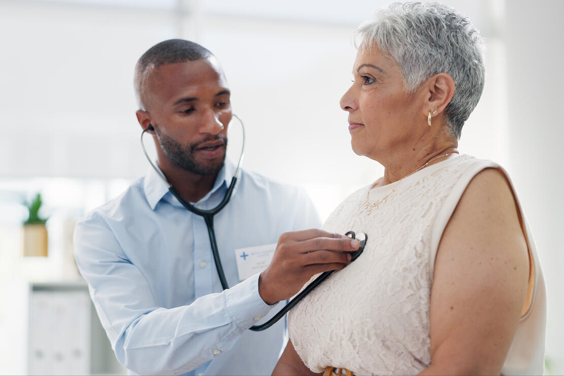 Stethoscope, examination and doctor with senior woman at hospital for lungs, chest or breathing assessment. Heart, listen and elderly patient consulting cardiologist for heartbeat, pulse or checkup