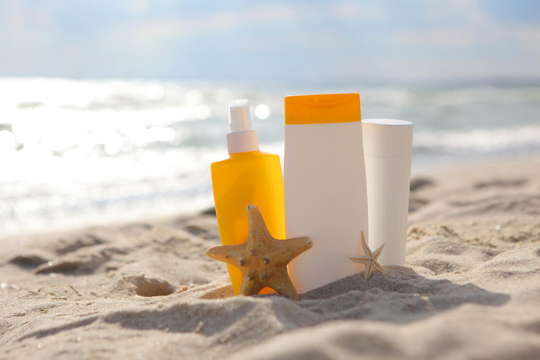 Sunscreens on the beach near the sea close up. High quality FullHD footage