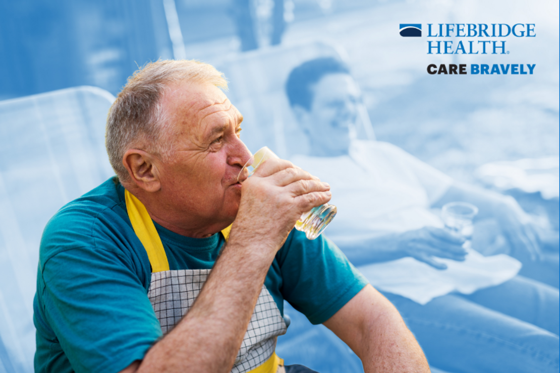 Older man sipping a glass of water while sitting in a lawn chair