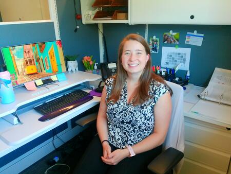 Image of Kaitlyn, a Family Advocate at Center for Hope, smiling warmly at her desk, ready to support families in need.