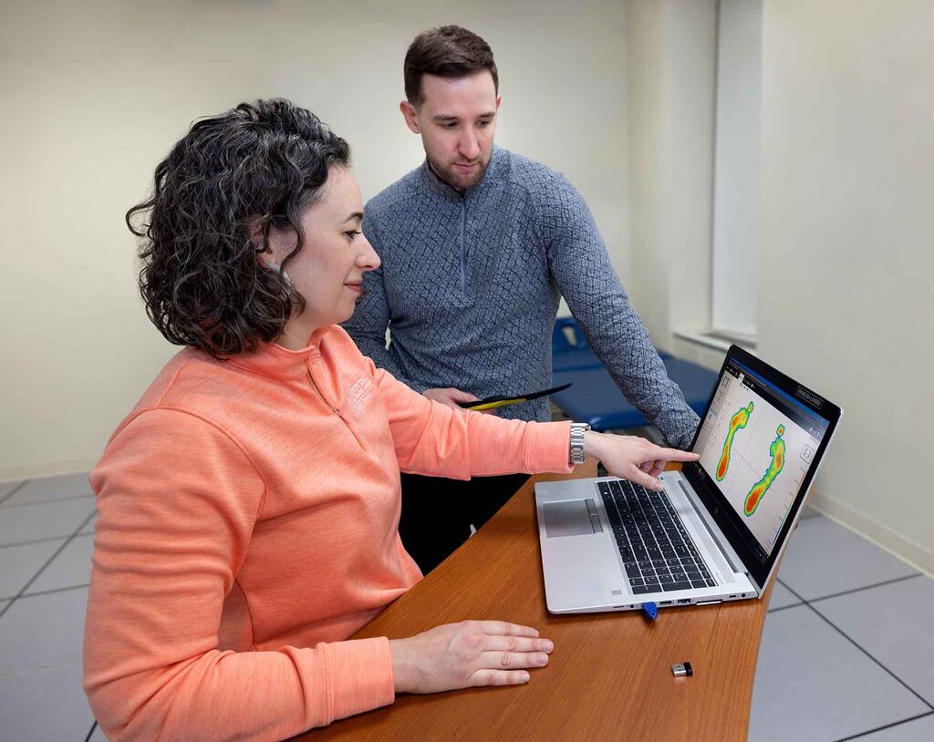 Patient and therapist reviewing a gait assessment
