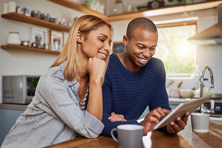 two people using a tablet to look at information