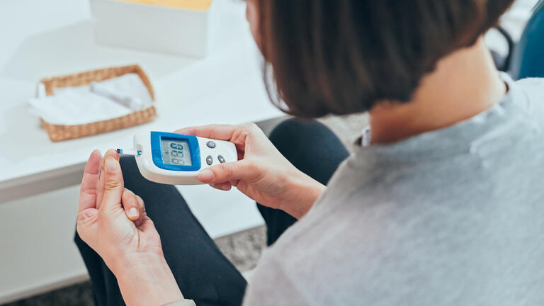 Women using a glucose monitor