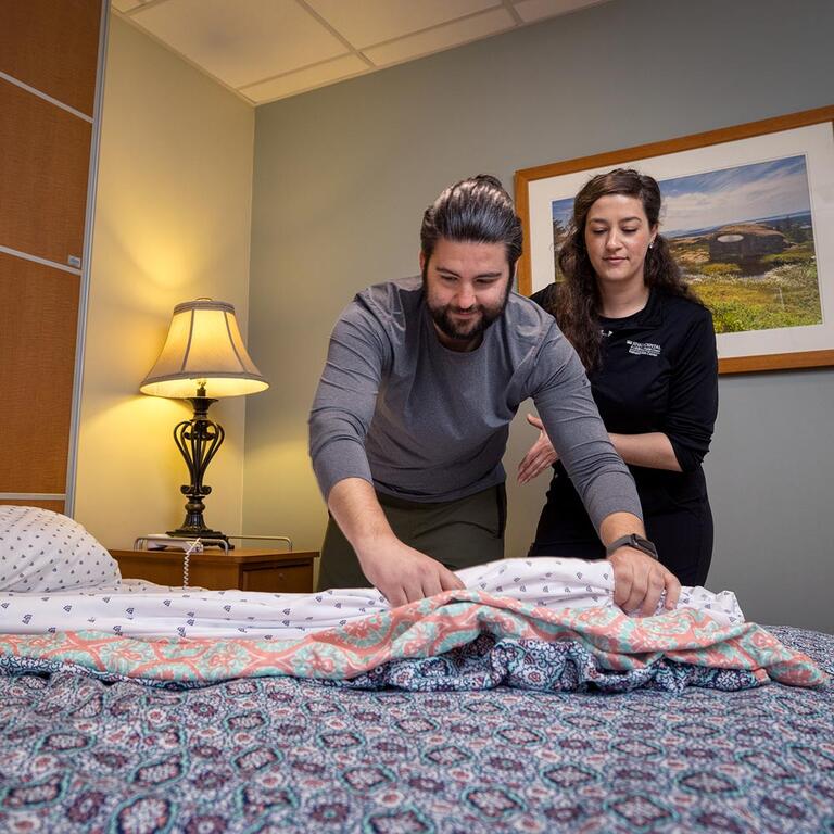 Therapist performing rehab by teaching patient life skills