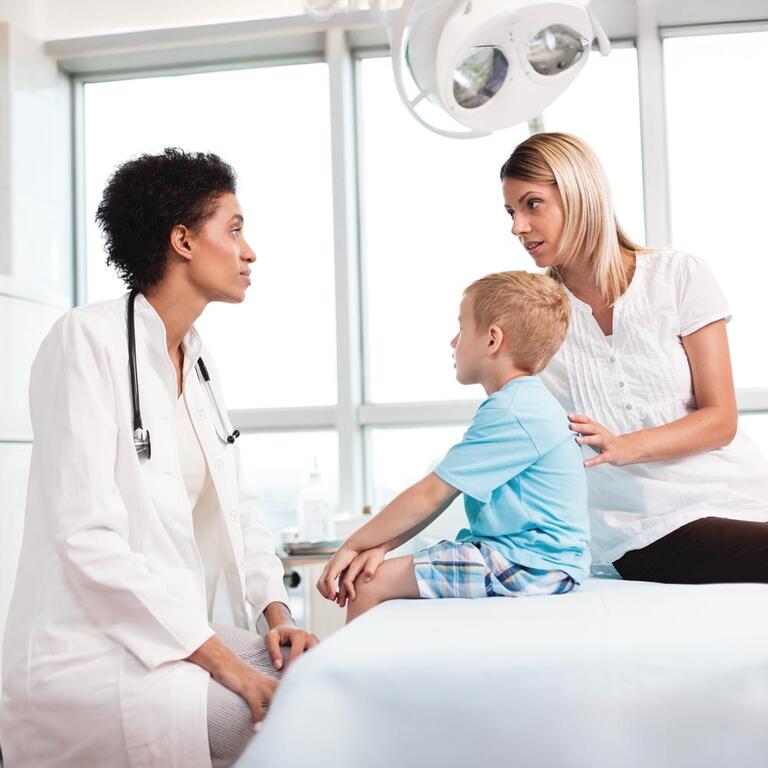 Doctor talking to a parent and young child