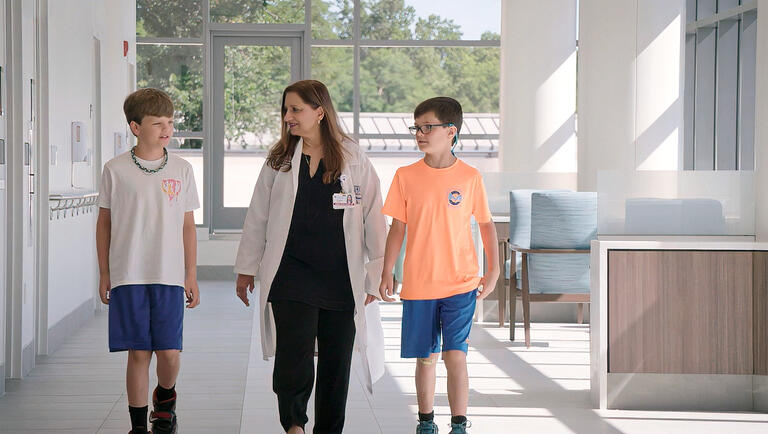 Dr. Shad Walking with Young Patients
