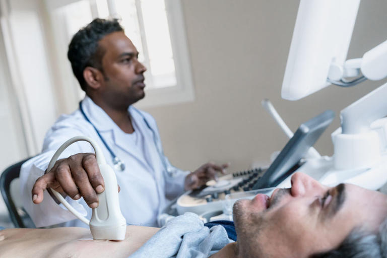 Cardiologist monitoring a heart with a medical device