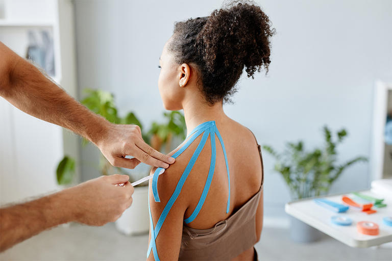 Taping a women's shoulder