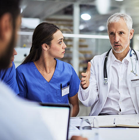 A doctor speaking with colleagues