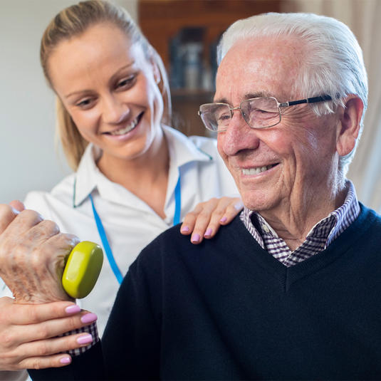 Physical therapist working with an elderly patient Physical therapist working with an elderly patient