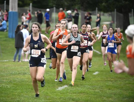 A group of cross country runners competing