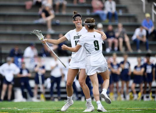 Two Loyola Women's Lacrosse players celebrating their healed rotator cuff
