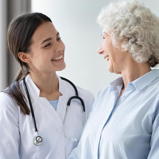 A resident talking to an elderly patient A resident talking to an elderly patient