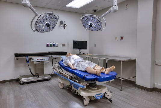 A practice dummy laying on a bed in the Simulation Center