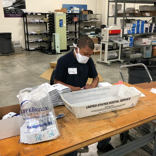 A young person working in the VSP print center A young person working in the VSP print center