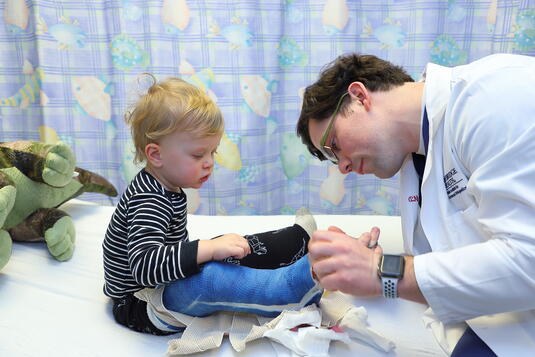 Orthopedist maryland working with a pediatric patient on their hand and wrist mobility