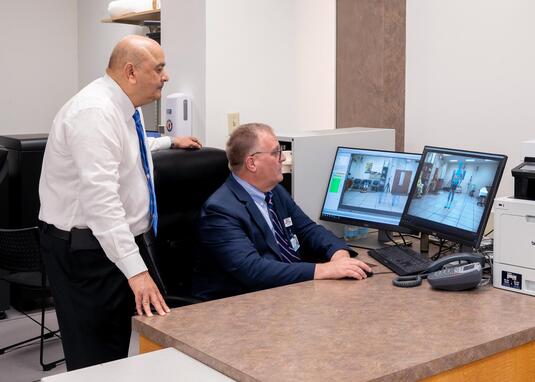 Doctor talking to a patient with a walker who is using the gait lab