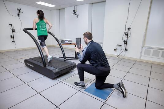 Doctor working with a patient to start running again