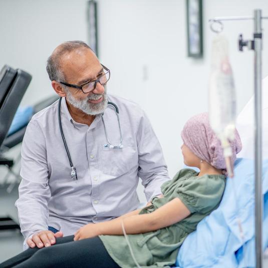 Doctor speaking with a young cancer patient