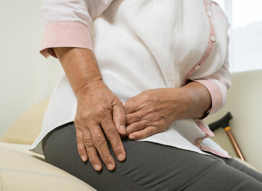 A person holding their hip