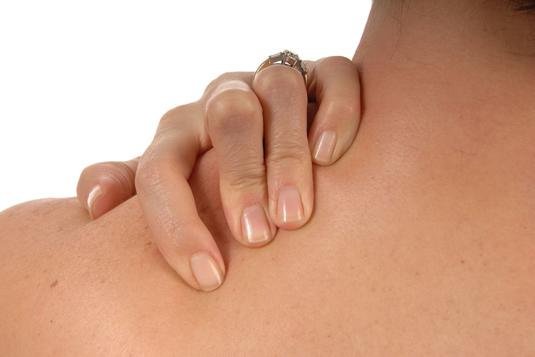 A woman holding her shoulder A woman holding her shoulder