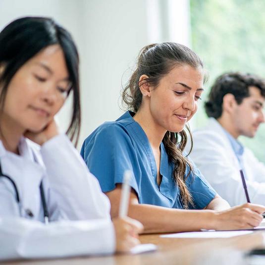 Nurses learning in a classroom setting Nurses learning in a classroom setting