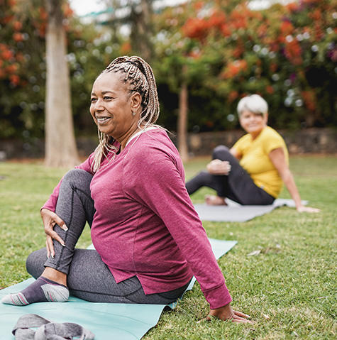 Diverse women at a yoga class in the park
