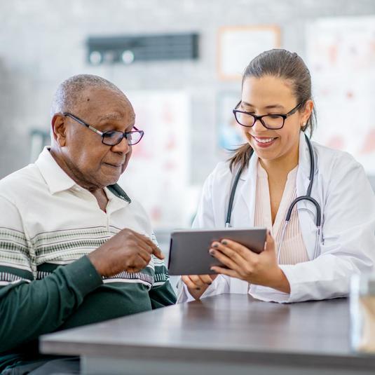 Image of a Physician talking with a research participant Image of a Physician talking with a research participant