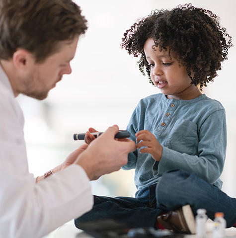 Child learning how to use an insulin pump