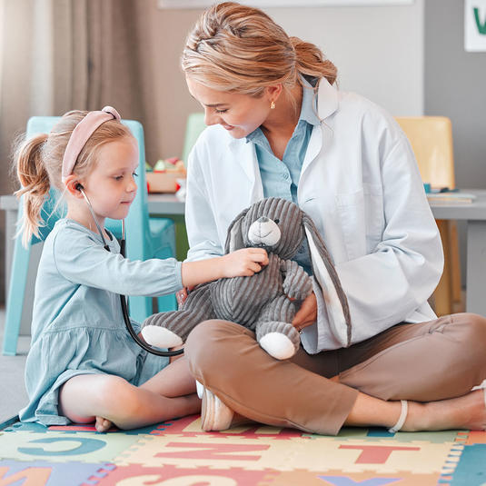 Pediatric patient in the hospital with a child life specialist Pediatric patient in the hospital with a child life specialist