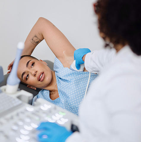 Patient receiving a breast exam