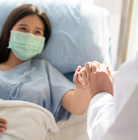 Patient with mask meeting with a doctor