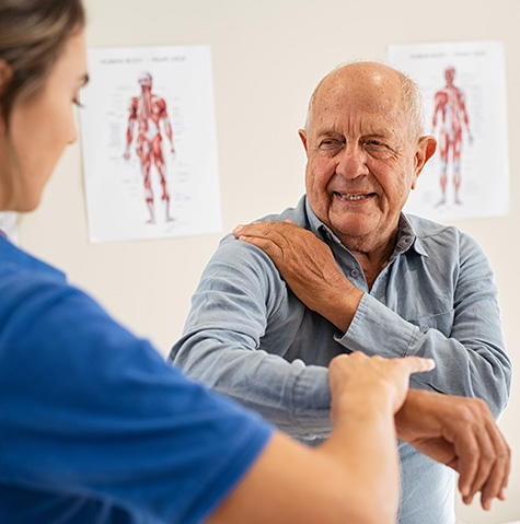 Patient working with a doctor on his shoulder pain
