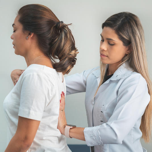 Doctor examines the patients posture