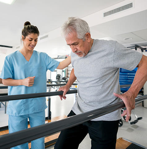 Patient in rehab walking on the bars during physical therapy at Northwest Hospital physical therapy