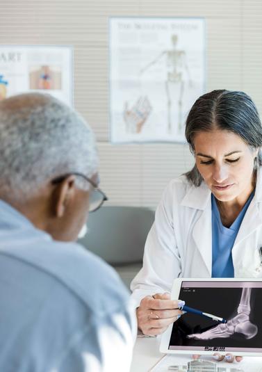 Patient and doctor reviewing a foot x-ray Patient and doctor reviewing a foot x-ray