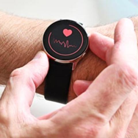 A hand using a smart watch on a person's wrist